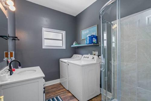 a bathroom with a washing machine and a shower at Wonderful 3 Bed 2 Bath House in Heart of YBOR City in Tampa