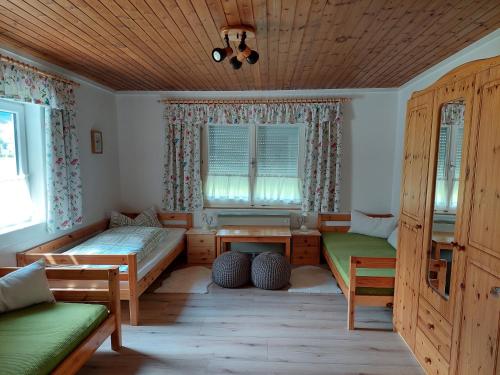 a room with two beds and a table in it at Haus Grünwald in Gosau