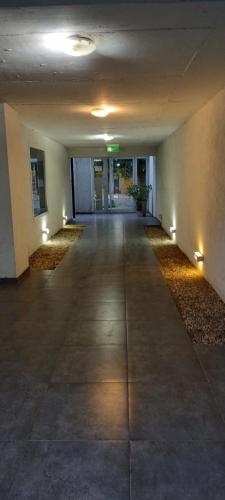 an empty hallway with lights in a building at El Racimo in Ciudad Lujan de Cuyo