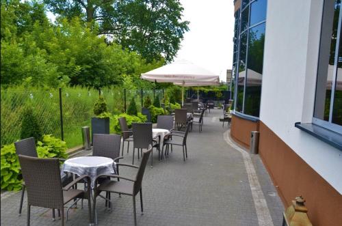 a row of tables and chairs on a patio at Bursztynowa in Łuków