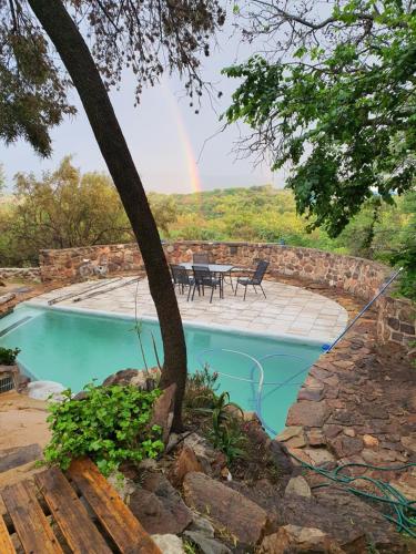 a pool with a rainbow in the background at Aurora Bushbaby 1 in Centurion