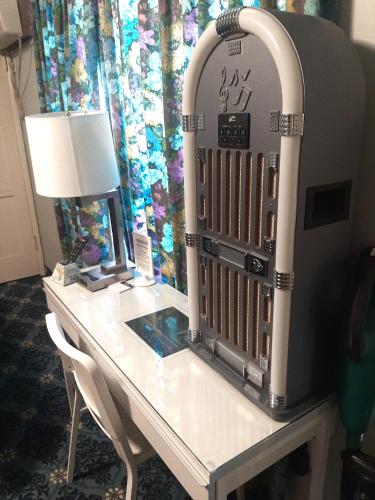 a desk in a hotel room with a large mirror at THE NEW STAR MOTEL - 1950s Extended-Stay Lodging and Retreat Center in Moreno Valley
