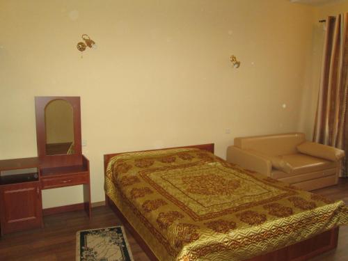 a bedroom with a bed and a dresser and a mirror at Rishelyevskiy in Odesa