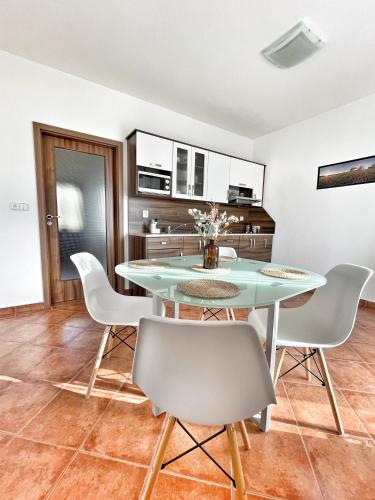 a dining room with a table and chairs at Penzion Kozí zámek in Horažďovice