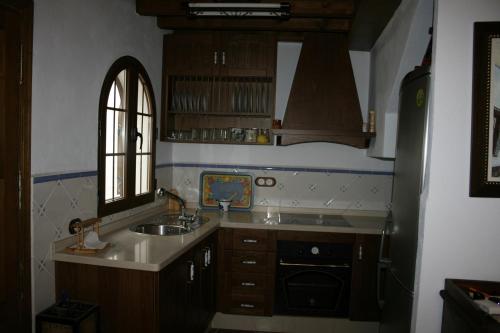 a small kitchen with a sink and a window at Casa Lentegí in Lentegí
