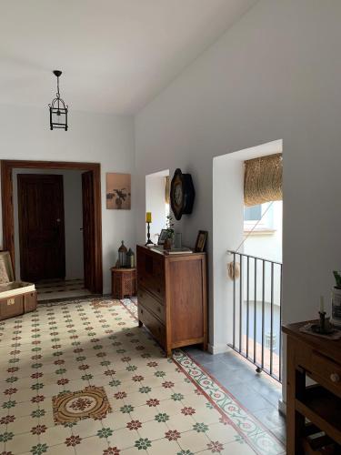 a living room with a clock on the wall at Casa de las Especias Hotel Boutique in Sanlúcar de Barrameda