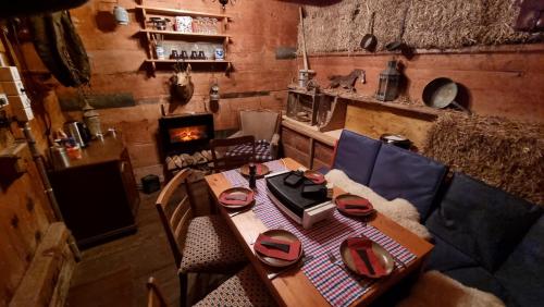 einen Holztisch in einem Zimmer mit Kamin in der Unterkunft Miramont Horse Trekking Hostel in Saicourt