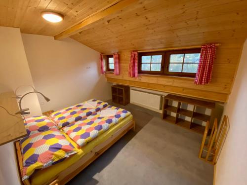 a small bedroom with a bed and a window at Apartmány Pod Kopcem in Bublava