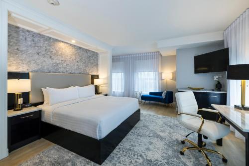 a hotel room with a bed and a desk and chair at Halifax Tower Hotel & Conference Centre, an Ascend Collection Hotel in Halifax