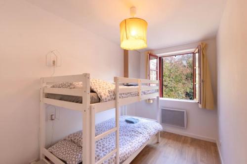 a bedroom with two bunk beds and a window at Cabana & L' Horeb - Hypercentre in Paray-le-Monial