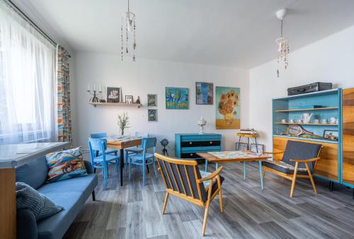 a living room with a couch and a table at Retro Art room in Lomnice nad Popelkou