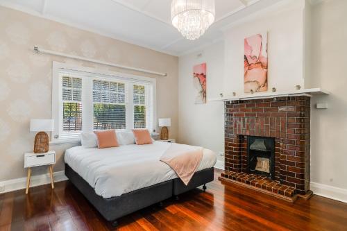 a bedroom with a bed and a fireplace at Swainson on Coombe in Woodville