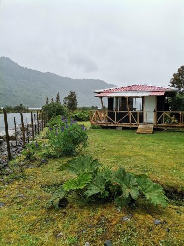 a small house with a garden in front of it at Departamento Rossbach in Puerto Puyuhuapi