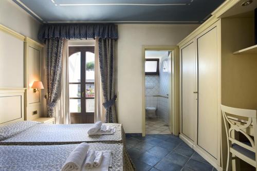 a room with a sink and a door at Hotel Poseidon in Terracina