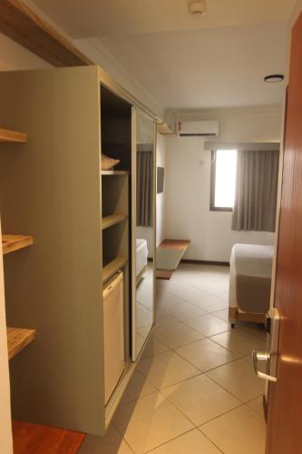 Кровать или кровати в номере Hotel Ilhas do Caribe - Na melhor região da Praia da Enseada