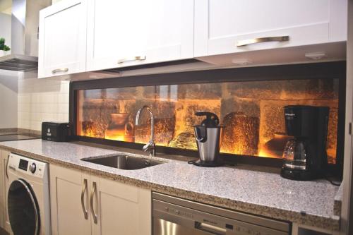 a kitchen with a fireplace in the background at CASA RURAL LA MANFORTA in Gata