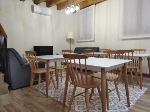 a dining room with white tables and chairs at CASA RURAL LA MANFORTA in Gata
