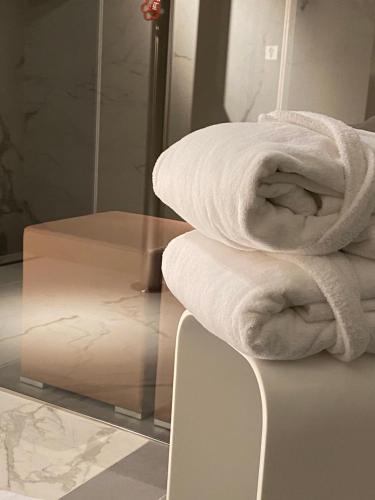 a stack of towels on a counter in a bathroom at DIMORA1934 Relax&Comfort in Tirano