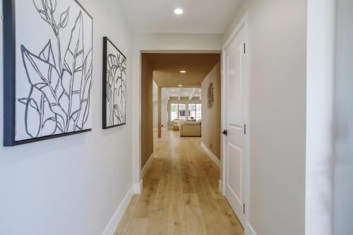 a hallway with white walls and wood floors at New 5 bed w/hot tub close to Universal sleeps 12 in Los Angeles