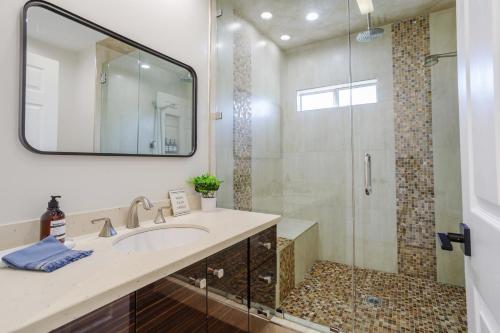 a bathroom with a sink and a shower at New 5 bed w/hot tub close to Universal sleeps 12 in Los Angeles