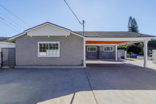 a house with a large driveway in front of it at New 5 bed w/hot tub close to Universal sleeps 12 in Los Angeles