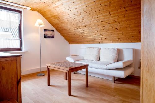 a living room with a couch and a table at Hummerklippen Ferienwohnungen in Helgoland