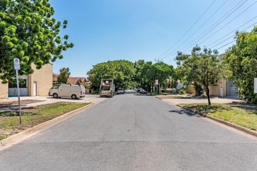 an empty street in a residential neighborhood with a van at Swainson on Coombe in Woodville