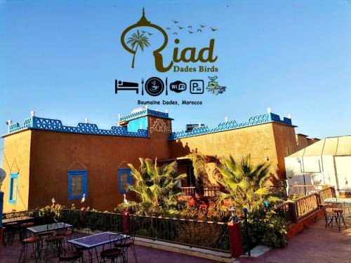 a restaurant with tables and chairs in front of a building at Riad Dades Birds in Boumalne Dades