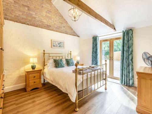 a bedroom with a bed and a window at Tawny Acre Barn - Uk38614 in Wisbech