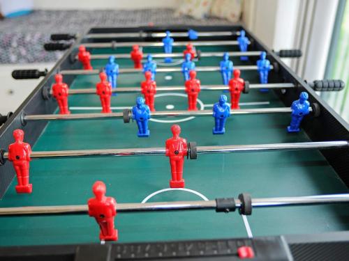 a group of red and blue figurines on a pool table at 8 person holiday home in Ansager in Ansager