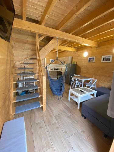 a room with a staircase in a log cabin at Tu Urlop in Mielno