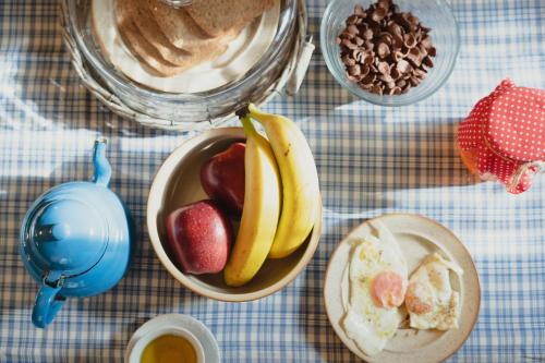 a table with a bowl of fruit and a bowl of food at Country house 2 in Ktistádes