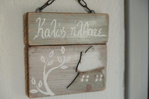 a sign hanging on a wall with a piece of bread at Country house 2 in Ktistádes