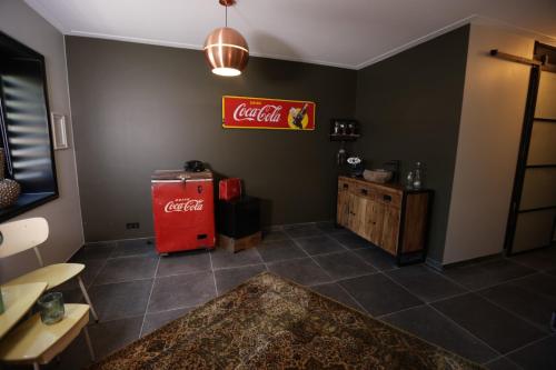an empty room with an old coca cola refrigerator at VET - Bed & Breakfast in Beek