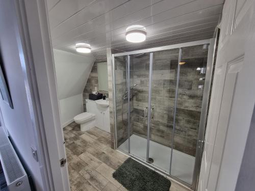 a bathroom with a shower and a toilet at Windsor house in Stranraer