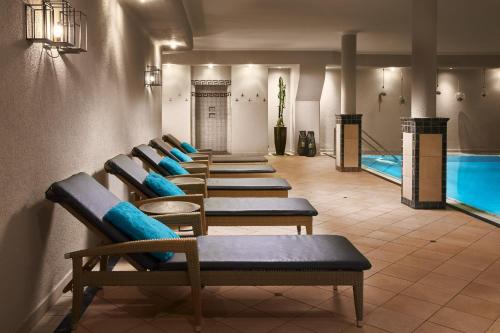 a row of benches in front of a pool at Alpinresort Stubaierhof ****s in Fulpmes