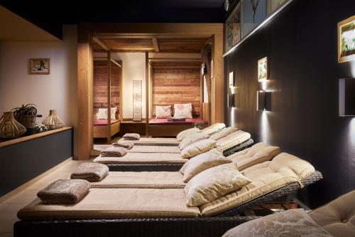 a row of beds lined up in a room at Alpinresort Stubaierhof ****s in Fulpmes