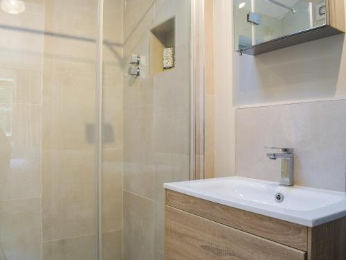 a bathroom with a sink and a shower at Holly Cottage Barn in Stoke Edith