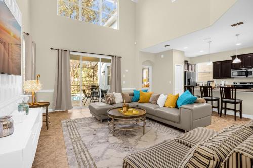 a living room with a couch and a table at Fun Family Villa Pool BBQ Near Disney World 5BR in Kissimmee