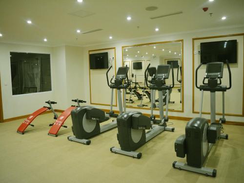 a gym with treadmills and ellipticals in a room at A25 Luxury Hotel in Hanoi