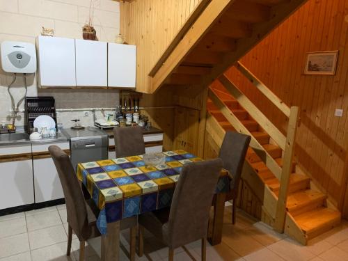 uma cozinha com uma mesa e cadeiras e uma escadaria em Guest House Đina em Žabljak