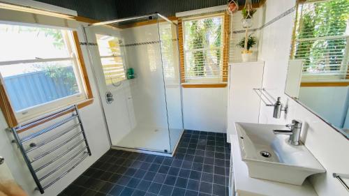 a bathroom with a shower and a sink at Absolute lakefront house - enjoy the sunrise in Budgewoi