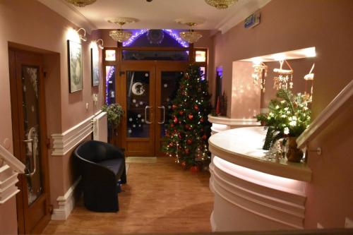 a room with a christmas tree in theoyer of a house at HOTEL GALERIA PEZINSKA BABA in Pezinok