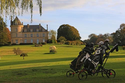 a man riding a bike in front of a castle at Hôtel de Boisgelin in Pléhédel