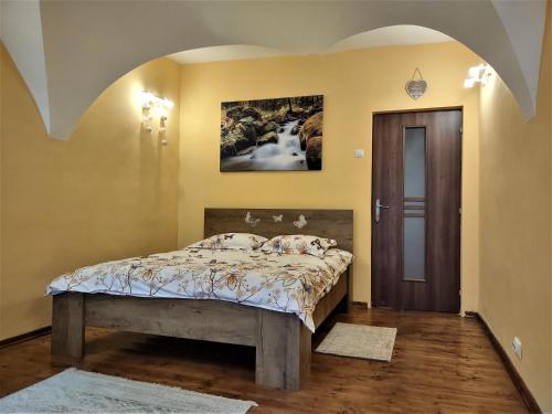 een slaapkamer met een bed met een schilderij aan de muur bij SMB Studio Poarta Schei in Braşov