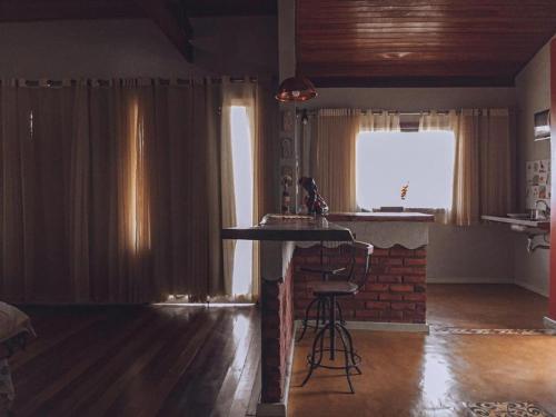 - un salon avec une table et une fenêtre dans l'établissement Chalés Lavras de Minas - Canadá, à Lavras Novas
