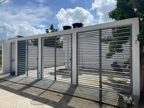 a metal gate with blinds on a deck at Work space Hostal in Uribia