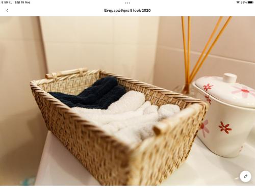 a basket of towels sitting on a counter in a bathroom at Country house with amazing sea view in Kassandra