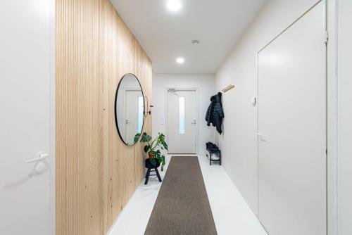 a hallway with white walls and a mirror at Villa Aurora in Rovaniemi