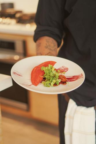 a person holding a plate with food on it at Casa Mirame in Carmen